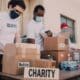 volunteer workers for a charity handing out boxes of supplies
